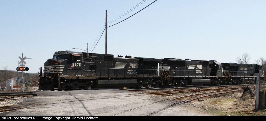 NS 9875 leads an empty grain train northbound